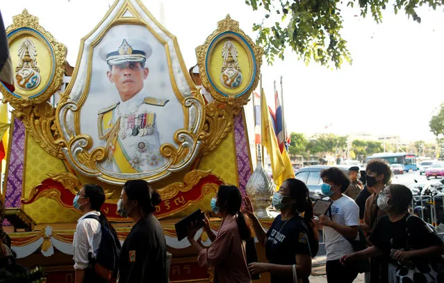 Demonstrators walk past a portrait of Thai King Maha Vajiralongkorn during a protest demanding the resignation of Thailand's Prime Minister Prayuth Chan-o-cha, in Bangkok, Thailand, July 26, 2020. (Photo by Jorge Silva/Reuters)
