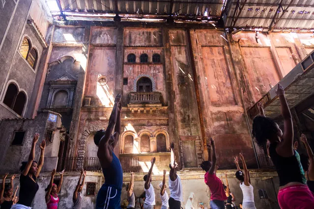 “Reach for the Stars”. This grand but weathered theatre in Havana, Cuba now serves as a dance studio for local dancers. The rough condition of the building is obscured by the obvious beauty behind the dust and the life and energy of the dancers within this space. Photo location: Havana, Cuba. (Photo and caption by Jerry Breaux/National Geographic Photo Contest)