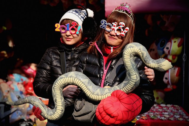The vendors show the toy of snake at the Spring Festival Temple Fair for celebrating Chinese Lunar New Year of Snake at the Temple of Earth park on February 9, 2013 in Beijing, China. The Chinese Lunar New Year of Snake also known as the Spring Festival, which is based on the Lunisolar Chinese calendar, is celebrated from the first day of the first month of the lunar year and ends with Lantern Festival on the Fifteenth day.  (Photo by Feng Li)
