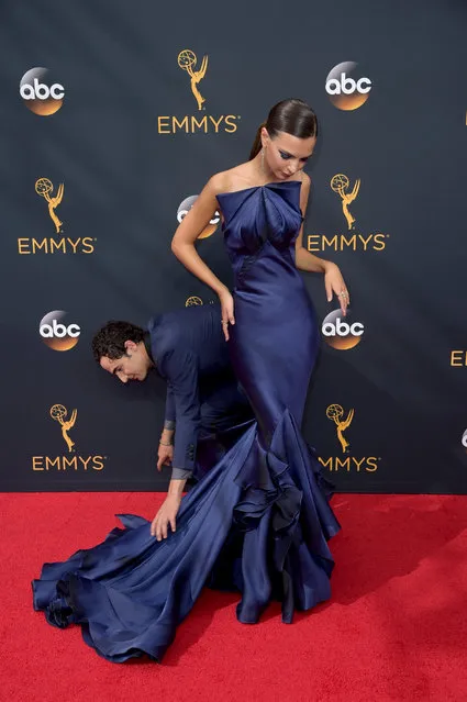 Designer Zac Posen, left, adjusts the dress of Emily Ratajkowski as they arrive at the 68th Primetime Emmy Awards on Sunday, September 18, 2016, at the Microsoft Theater in Los Angeles. (Photo by Richard Shotwell/Invision/AP Photos)