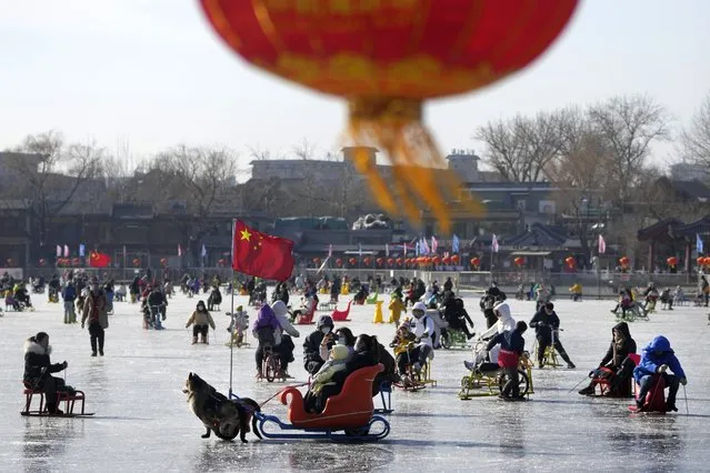 Residents enjoy skating on the frozen Houhai Lake in Beijing, Monday, January 16, 2023. The World Health Organization has appealed to China to keep releasing information about its wave of COVID-19 infections after the government announced nearly 60,000 deaths since early December following weeks of complaints it was failing to tell the world what was happening. (Photo by Andy Wong/AP Photo)