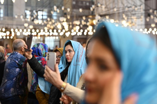 People take selfies inside the Blue Mosque, during Eid al-Fitr, in Istanbul, Turkey, on March 31, 2025. (Photo by Dylan Martinez/Reuters)