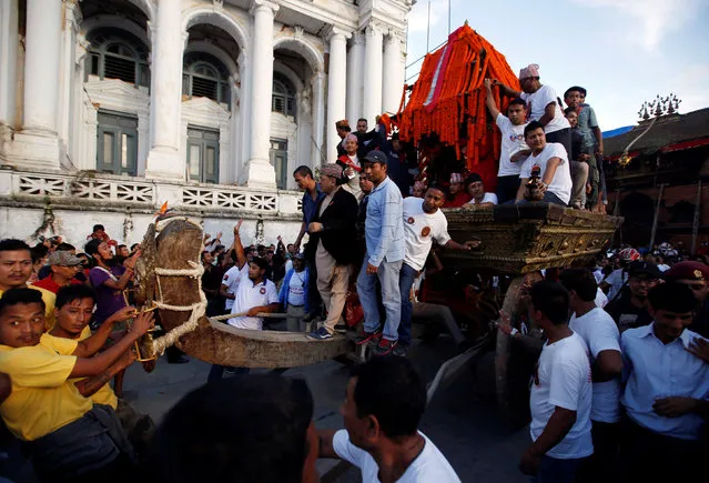 Devotees pull the chariot of Nepal's Living Goddess Kumari during the Indra Jatra festival in Kathmandu, Nepal September 15, 2016. (Photo by Navesh Chitrakar/Reuters)
