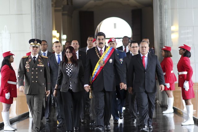 National Assembly President Diosdado Cabello (R), Venezuela's President Nicolas Maduro, his wife Cilia Flores and Minister of Defense Vladimir Padrino Lopez (L) arrive for a ceremony at the National Pantheon in Caracas, Venezuela, in this handout picture provided by Miraflores Palace on October 23, 2015. (Photo by Reuters/Miraflores Palace)