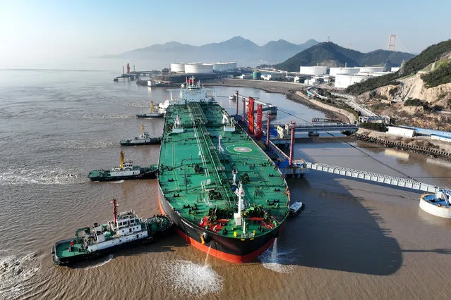 Tugboats push the crude oil tanker Habrut to a reception terminal operated by China Petrochemical Corporation or Sinopec Group on January 30, 2023 in Zhoushan, Zhejiang Province of China. (Photo by VCG/VCG via Getty Images)