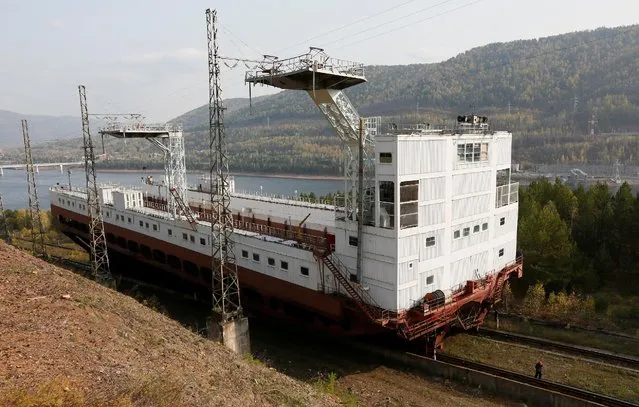 An employee walks past a shiplift, which is used to allow passage of ships past the dam situated on the Yenisei River, at the Krasnoyarsk hydro electric power station outside Krasnoyarsk, Siberia, Russia, October 3, 2016. (Photo by Ilya Naymushin/Reuters)