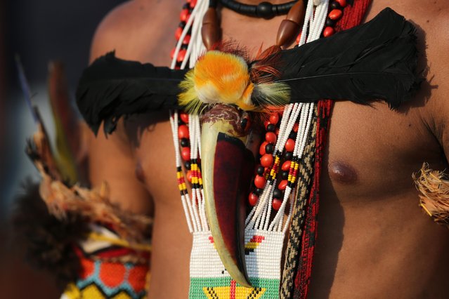 A Pataxo Indian, of Brazil, wears a toucan's beak during competition at the World Indigenous Games in Palmas, Brazil, Thursday, October 29, 2015. (Photo by Eraldo Peres/AP Photo)