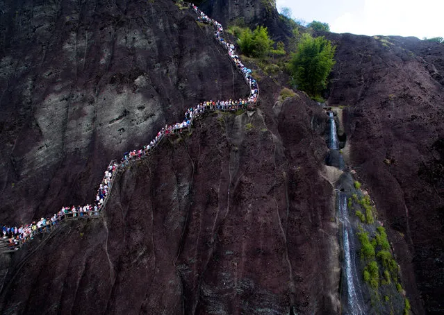 Visitors walk on a path at Wuyi mountain in Nanping, Fujian Province, China, October 3, 2016. (Photo by Reuters/Stringer)