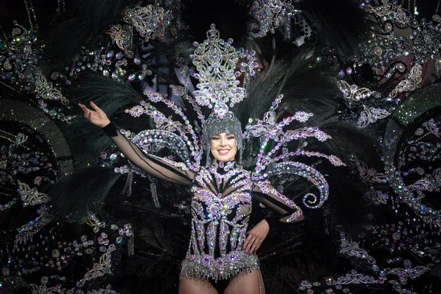 A nominee for Queen of the Carnival performs during the Carnival of Santa Cruz in Santa Cruz de Tenerife on the Spanish Canary island of Tenerife, on February 15, 2023. The candidates for Queen of the Carnival wear costumes of more than five-meter high and over 80 kilos in weight. Considered one of the most popular and well-known in the world after that of Rio de Janeiro (Brazil), the Carnival of Santa Cruz de Tenerife offers festivities that range from the election of the Carnival Queen, children and adult murgas (satirical street bands), comparsas (dance groups) to performances on the streets. (Photo by Desiree Martin/AFP Photo)