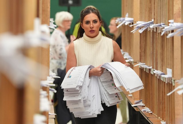 Count staff sort ballots at Nemo Rangers GAA club for the local and European Parliament elections, in Cork, Ireland, Sunday June 9, 2024. (Photo by Jonathan Brady/PA Wire via AP Photo)