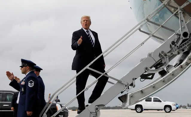 U.S. President Donald Trump gives a thumbs up as he boards Air Force One upon departure from West Palm Beach, Florida, U.S., on his way back to Washington April 22, 2018. (Photo by Kevin Lamarque/Reuters)