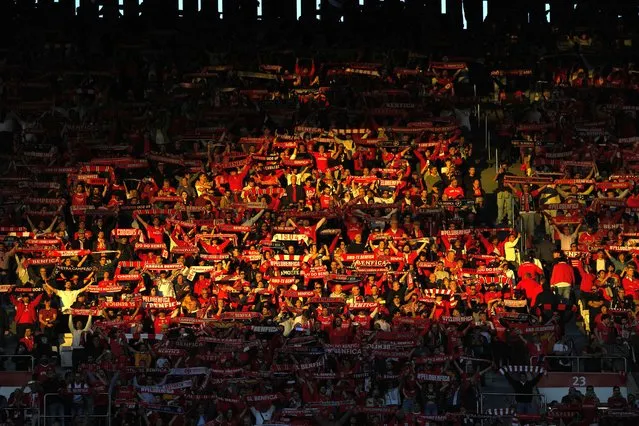 Benfica supporters hold up team scarfs prior the Champions League quarter final first leg soccer match between Benfica and Inter Milan at Luz stadium in Lisbon, Tuesday, April 11, 2023. (Photo by Armando Franca/AP Photo)