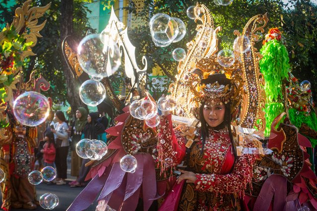 A performer poses in an extravagant costume during the Solo Batik Carnival in Surakarta, Central Java on July 13, 2024. (Photo by Devi Rahman/AFP Photo)