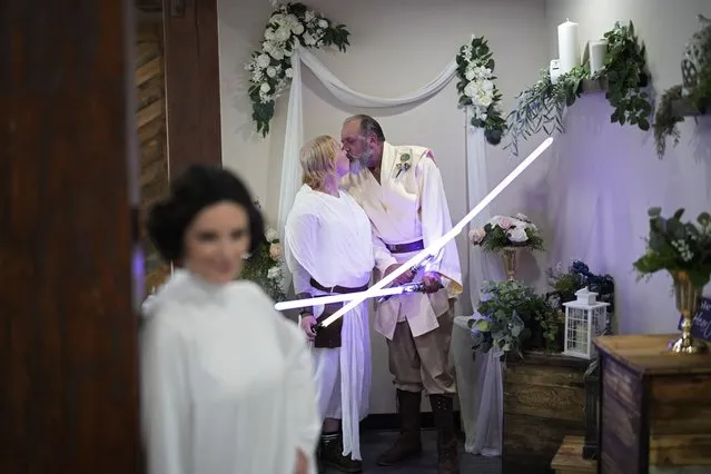 Michael Van Worner, right, kisses Erin Clemens after their Star Wars themed wedding at The Little Vegas Chapel, Thursday, May 4, 2023, in Las Vegas. The chapel held Star Wars weddings for Star Wars Day - observed by fans globally on May 4 with a slight change in the iconic catchphrase; from “May the Force be with you” to “May the Fourth be with you”. (Photo by John Locher/AP Photo)