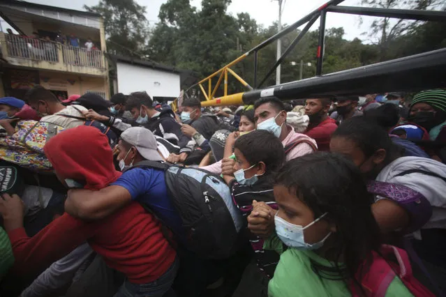 Honduran migrants hoping to reach the U.S. cross the border patrolled by Guatemalan soldiers, in El Florido, Guatemala, Saturday, January 16, 2021. (Photo by Sandra Sebastian/AP Photo)