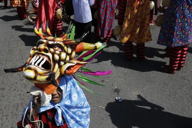 A child dressed in a traditional costume is seen during the Diablicos Sucios or Dirty Devils dance parade in Las Tablas, in the province of Los Santos January 11, 2015. (Photo by Carlos Jasso/Reuters)