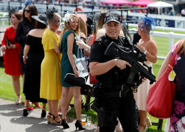 An armed police officer on patrol during the Investec Ladies Day at Epsom Downs on June 1, 2018 in Epsom, England. (Photo by Peter Nicholls/Reuters)