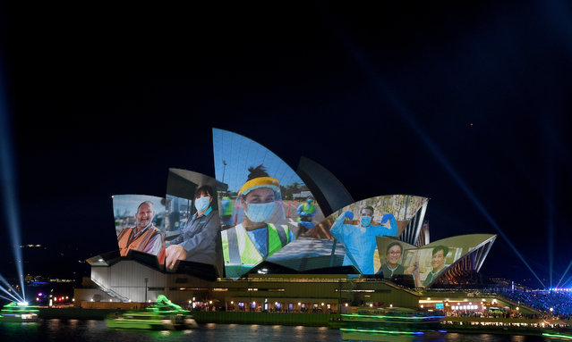 Images of essential workers are projected onto the sails of the Sydney Opera House during Australia Day celebrations at Circular Quay, in Sydney, Tuesday, January 26, 2021. (Photo by Dan Himbrechts/AAP Image)