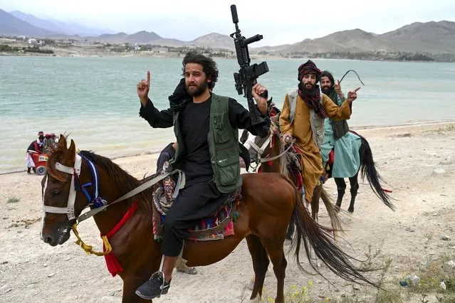 Taliban security forces ride horses along the Qargha Lake on the outskirts of Kabul on May 11, 2023. (Photo by Wakil Kohsar/AFP Photo)