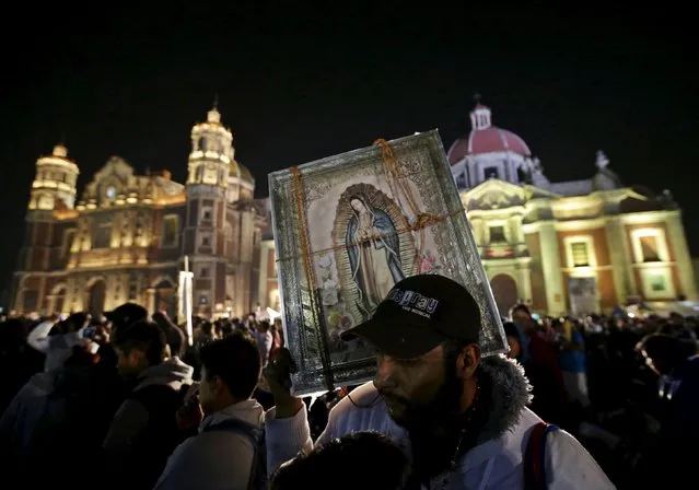 A pilgrim holds up an image of the Virgin of Guadalupe at the Basilica of Guadalupe during the annual pilgrimage in honor of the Virgin of Guadalupe, patron saint of Mexican Catholics, in Mexico City, Mexico December 12, 2015. (Photo by Henry Romero/Reuters)