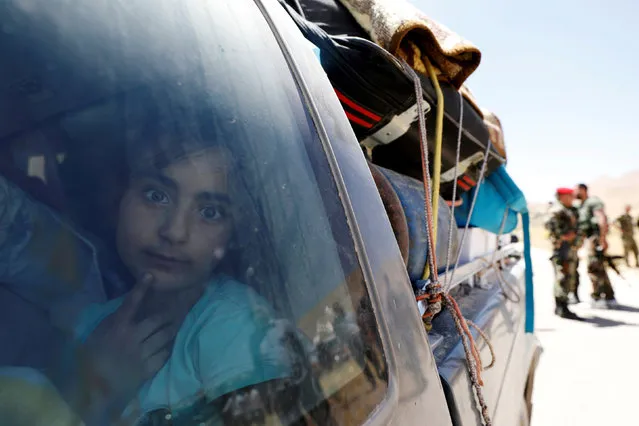 A Syrian refugee girl who left Lebanon looks through a window as she arrives in Qalamoun, Syria June 28, 2018. (Photo by Omar Sanadiki/Reuters)