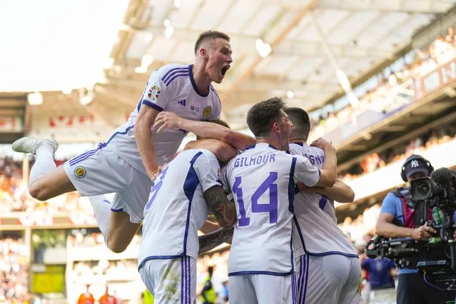 Lyndon Dykes (2L) of Scotland celebrates with teammates after scoring the 1-1 goal during the UEFA EURO 2024 qualifying soccer match between Norway and Scotland, in Oslo, Norway, 17 June 2023. (Photo by Fredrik Varfjell/EPA)
