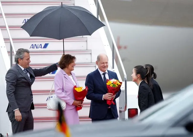 German Chancellor Olaf Scholz accompanied by his wife Britta Ernst, arrives at Hiroshima airport, ahead of the G7 leaders' summit in Mihara, Hiroshima, Japan on May 18, 2023. (Photo by Androniki Christodoulou/Reuters)