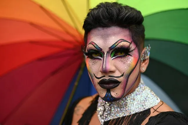 A person looks on as members of the LGBTQ+ community take part in the Latin American Gay Pride parade, in Caracas, Venezuela on July 2, 2023. (Photo by Gaby Oraa/Reuters)