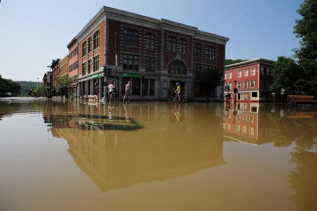 Residents look over the damage after flooding from recent rain storms in Montpelier, Vermont, U.S., July 11, 2023. (Photo by Brian Snyder/Reuters)