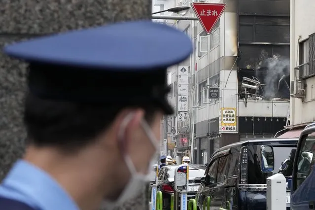 A police officer stands guard near the scene of an explosion in a building Monday, July 3, 2023, in Tokyo. (Photo by Eugene Hoshiko/AP Photo)