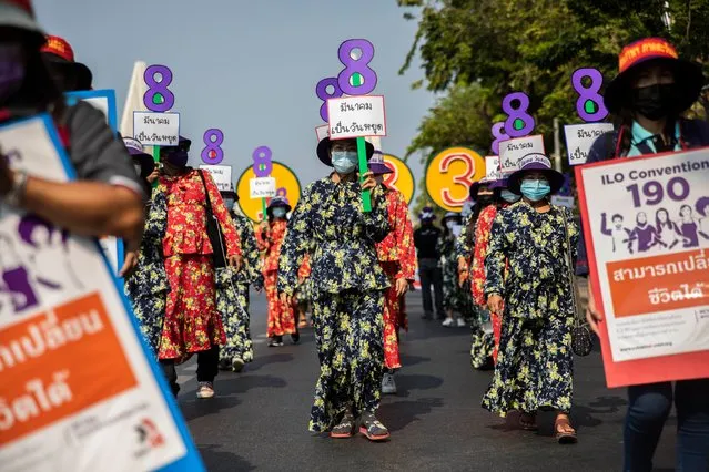 Women rally for maternity rights and workers rights while holding up signs in the shape of the number 8 to commemorate international women's day on March 08, 2021 in Bangkok, Thailand. Members of Thai labor unions and women's networks march from Democracy Monument to Government House calling for women workers rights and maternity rights on International Women's Day. The demonstration aimed to draw attention to the International Labor Organization's C190 and C183, which are laws concerning harassment and violence in the workplace and maternity protection. (Photo by Lauren DeCicca/Getty Images)