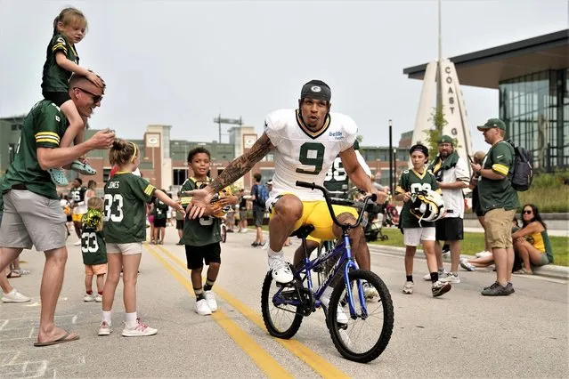 Christian Watson #9 of the Green Bay Packers rides a bike to practice during training camp at Ray Nitschke Field on August 01, 2023 in Ashwaubenon, Wisconsin. (Photo by Patrick McDermott/Getty Images)