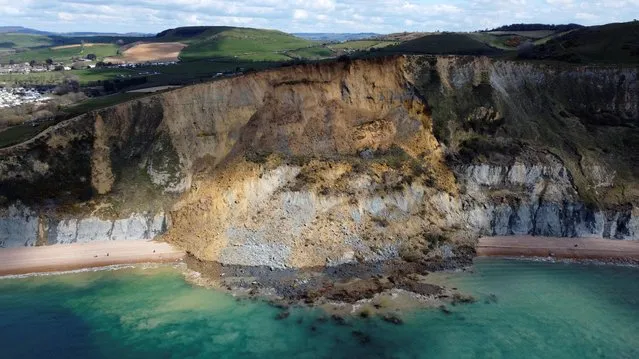 Rockfall is seen on a beach after a cliff collapsed near the village of Seatown, Dorset, Britain, April 16, 2021. Picture taken with a drone. (Photo by Carl Recine/Reuters)
