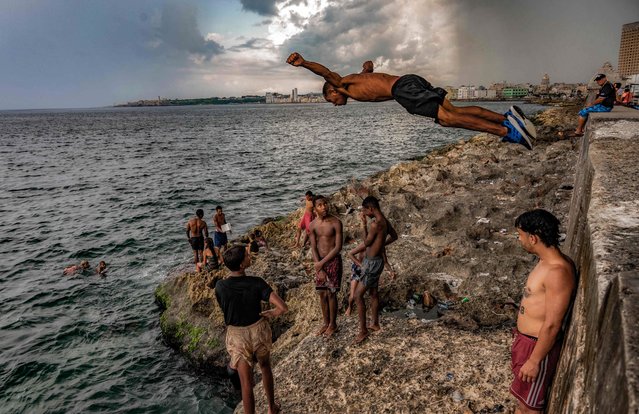 Youngsters bathe on Havana's Malecon waterfront on July 6, 2023. The planet recorded its hottest day this week, reaching 17.18° Celsius. This record had already been broken last Monday. Scientists warn that this situation could be repeated on more occasions during 2023. (Photo by Yamil Lage/AFP Photo)