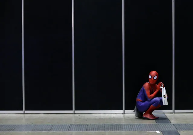 A man in a Spider-Man costume takes a rest at Tokyo Comic Con at Makuhari Messe in Chiba, Japan December 2, 2016. (Photo by Issei Kato/Reuters)