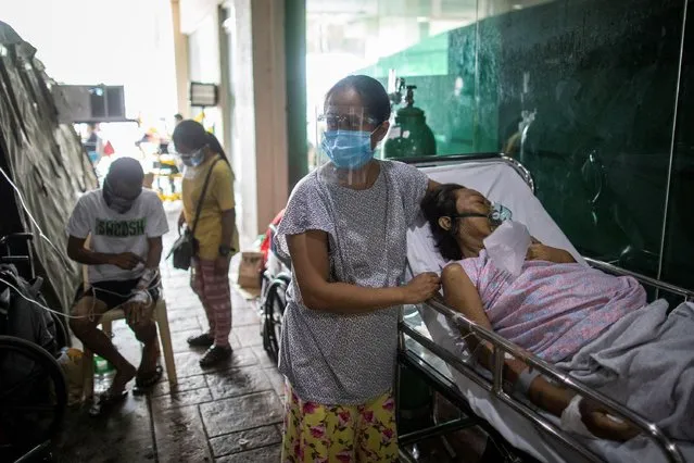 Patients are treated outside the COVID-19 emergency room of the government hospital National Kidney and Transplant Institute in Quezon City, which has declared overcapacity amid rising numbers of coronavirus disease (COVID-19) infections in Metro Manila, Philippines, April 26, 2021. (Photo by Eloisa Lopez/Reuters)