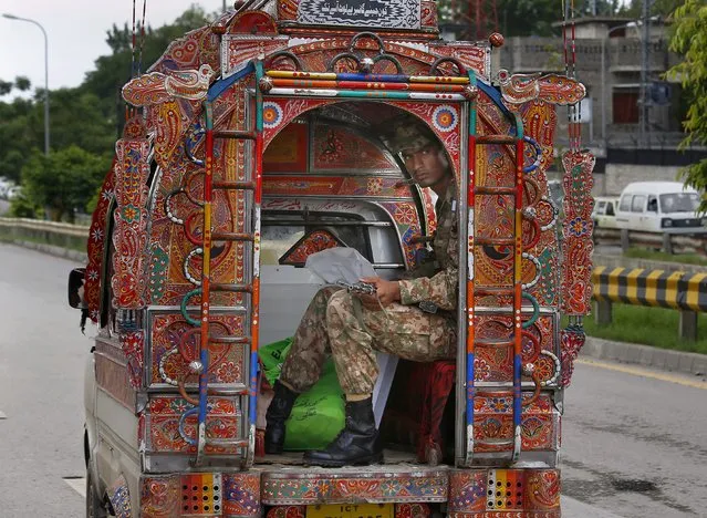 A Pakistani soldier guards to polling material transported to polling stations, in Rawalpindi, Pakistan, Tuesday, July 24, 2018. As Pakistan prepares to make history Wednesday by electing a third straight civilian government, rights activists, analysts and candidates say the campaign has been among its dirtiest ever, imperiling the country's wobbly transition to democratic rule. (Photo by Anjum Naveed/AP Photo)