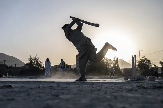 Afghan youth play cricket in a field in Kabul on September 3, 2023. (Photo by Wakil Kohsar/AFP Photo)