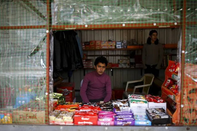 Syrian refugee Resad Bekur, 18, poses in a shop where he works in Yayladagi refugee camp in Hatay province, near the Turkish-Syrian border, Turkey, December 16, 2015. (Photo by Umit Bektas/Reuters)