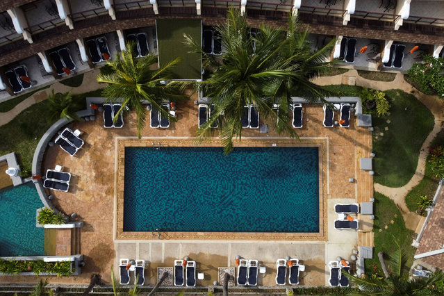 Empty sunbeds are seen around the swimming pool of a hotel, which has opened for visitors in Karon, Phuket Island, Thailand on April 2, 2021. (Photo by Jorge Silva/Reuters)
