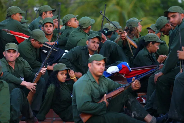 Cuban soldiers rest after participating in the celebration of the 60th anniversary of the arrival of Fidel Castro and fellow revolutionaries in the Granma yacht, in Playa Las Coloradas, Cuba, December 2, 2016. (Photo by Ivan Alvarado/Reuters)