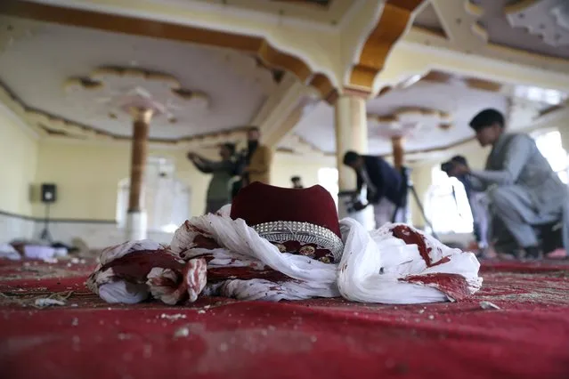 A blood-stained turban and cap are seen inside a mosque after a bomb explosion in Shakar Dara district of Kabul, Afghanistan, Friday, May 14, 2021. A bomb ripped through a mosque in northern Kabul during Friday prayers killing 12 worshippers, Afghan police said. (Photo by Rahmat Gul/AP Photo)