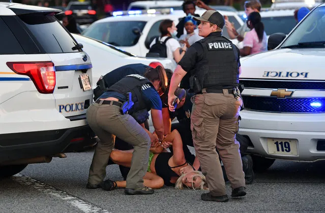 Police officers take a protester into custody during protest against police brutality and the arrest of two brothers Ricky and Travis Price in Rock Hill, South Carolina, United States on June 24, 2021. (Photo by Peter Zay/Anadolu Agency via Getty Images)