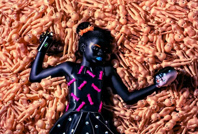 The photos in the series are divided into 15 zones, each defined by a distinctive theme and style. This image of a young black girl lying in a sea of white dolls is from the zone titled “Angry Dolls”. (Photo by Kolor Art Collective/The Guardian)