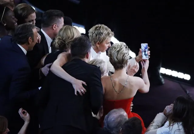Host Ellen Degeneres takes a group picture at the 86th Academy Awards in Hollywood, California, in this March 2, 2014 file photo. (Photo by Lucy Nicholson/Reuters)
