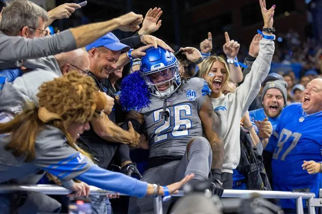 Detroit Lions running back Jahmyr Gibbs (26) jumps into the stands and celebrates his touchdown against the Las Vegas Raiders with fans at Ford Field in Detroit on October 31, 2023. (Photo by David Reginek/USA TODAY Sports)