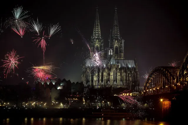 Fireworks illuminate the sky next to the Cologne Cathedral during the New Year's Eve celebrations in Cologne, Germany, 01 January 2019. As a result of the mass sexual assaults on New Year's Eve 2015/2016, North Rhine-Westphalian police will be in operation with about 5,500 officers at the upcoming turn of the year. (Photo by Friedemann Vogel/EPA/EFE)