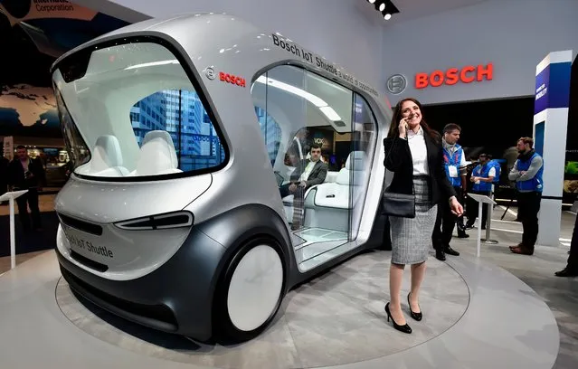 A Bosch representative stands near an automatous shuttle on display at the Bosch booth at CES 2019 at the Las Vegas Convention Center on January 8, 2019 in Las Vegas, Nevada. CES, the world's largest annual consumer technology trade show, runs through January 11 and features about 4,500 exhibitors showing off their latest products and services to more than 180,000 attendees. (Photo by David Becker/Getty Images)