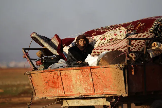 A woman rides a vehicle stacked with belongings after fleeing clashes in the northern Syrian town of al-Bab, Syria January 7, 2017. (Photo by Khalil Ashawi/Reuters)