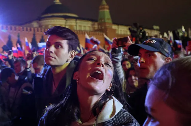 A spectator reacts during a concert marking the declared annexation of the Russian-controlled territories of four Ukraine's Donetsk, Luhansk, Kherson and Zaporizhzhia regions, after holding what Russian authorities called referendums in the occupied areas of Ukraine that were condemned by Kyiv and governments worldwide, in Red Square in central Moscow, Russia on September 30, 2022. (Photo by Reuters/Stringer)